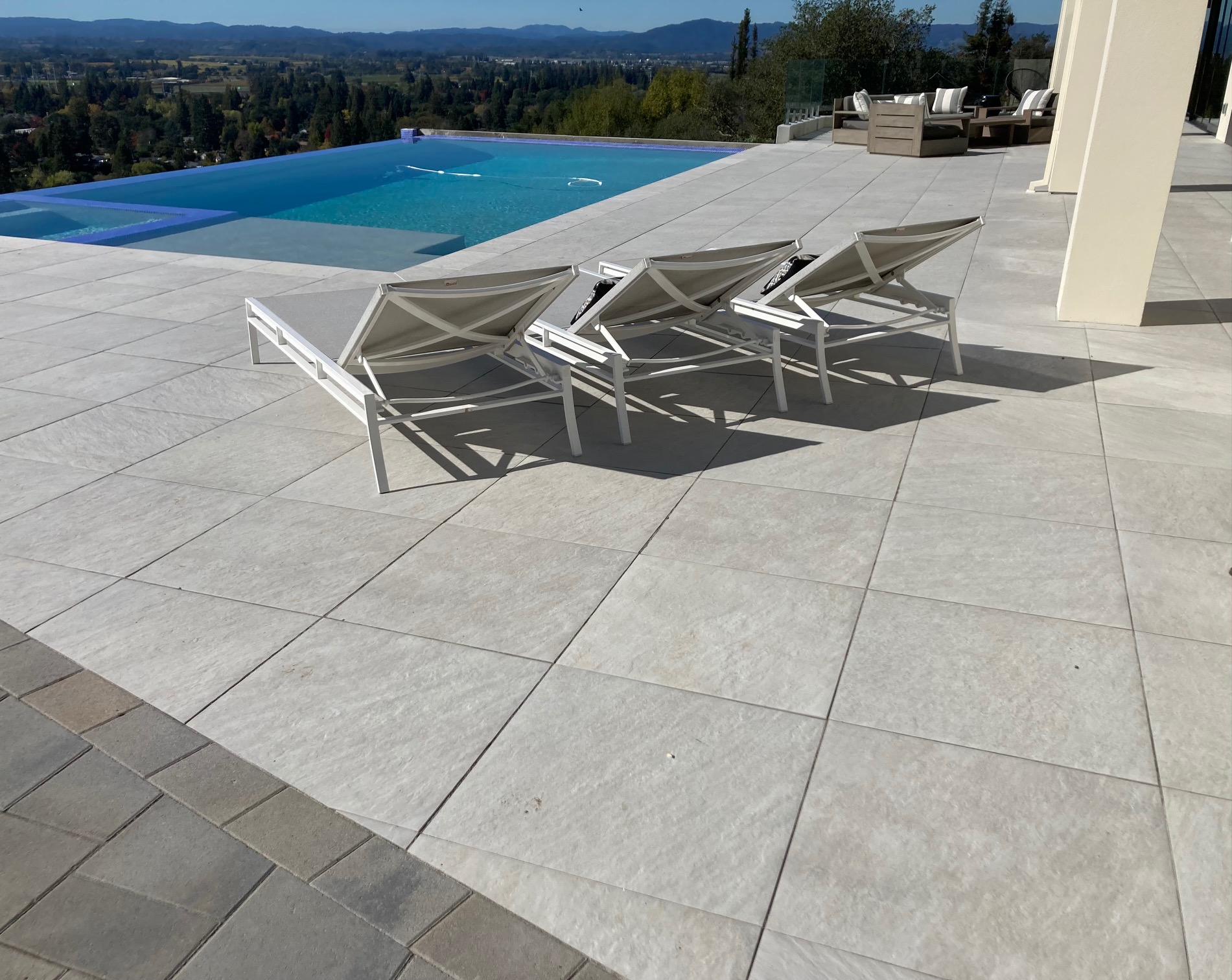 Stone paver pool deck by the Legacy Paver Group.